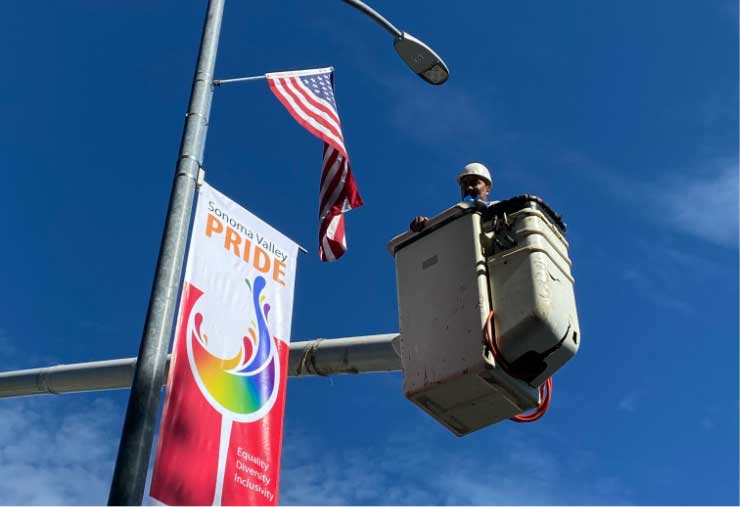 Pride banners being hung up around the Sonoma square